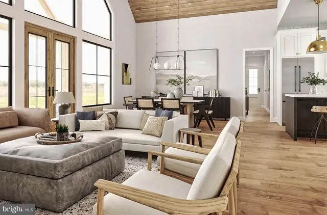 a living room with furniture large windows and wooden floor