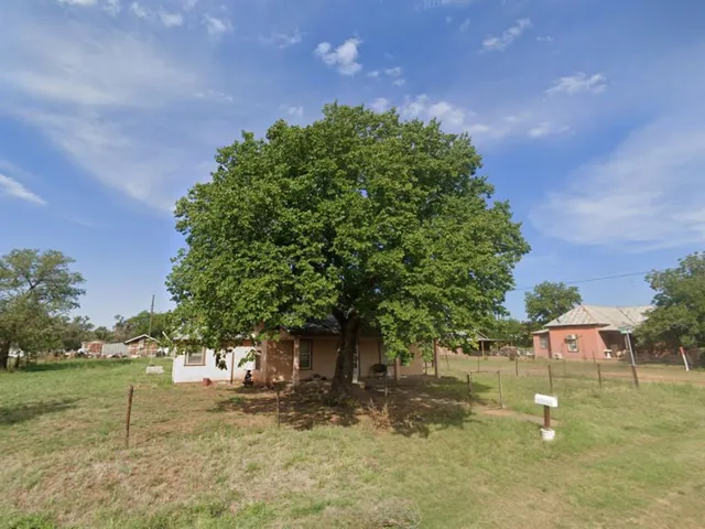 a backyard of a house with lots of green space