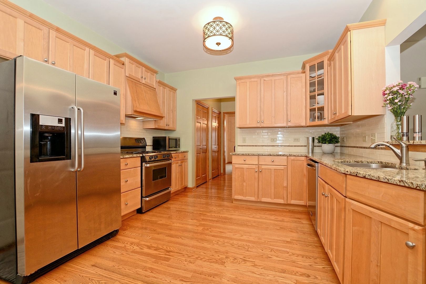 916 Merrill New Road Sugar Grove, IL 60554 - Photo 5 of 23 a kitchen with granite countertop a refrigerator oven a sink and dishwasher