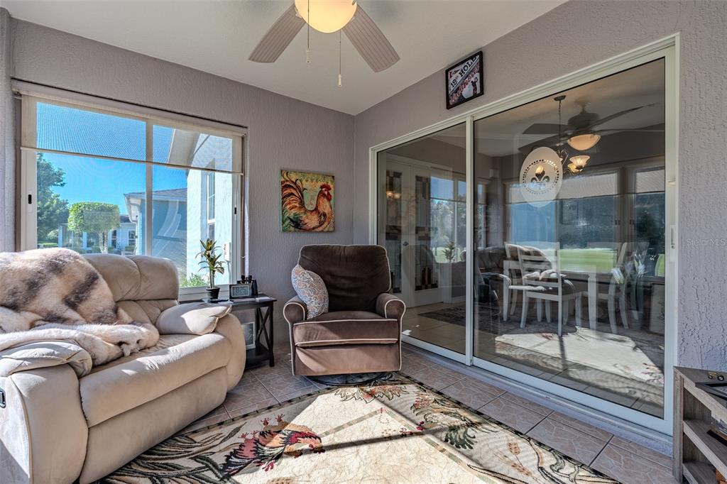 15143 Southwest 14th Avenue Road Ocala, FL 34473 - Photo 17 of 53 a living room with furniture and a glass door