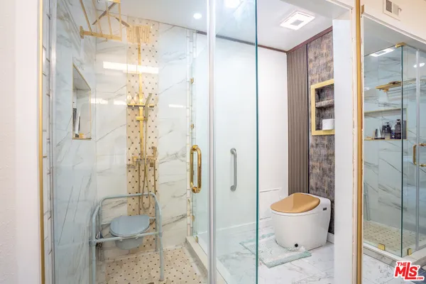 a bathroom with a glass shower door