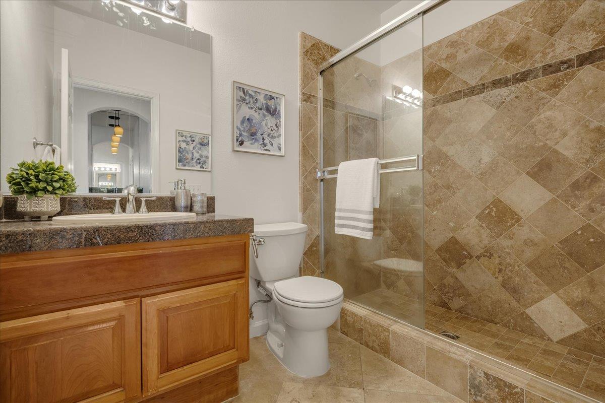 6315 Skywalker Drive San Jose, CA 95135 - Photo 26 of 34 a bathroom with a granite countertop sink a toilet and shower