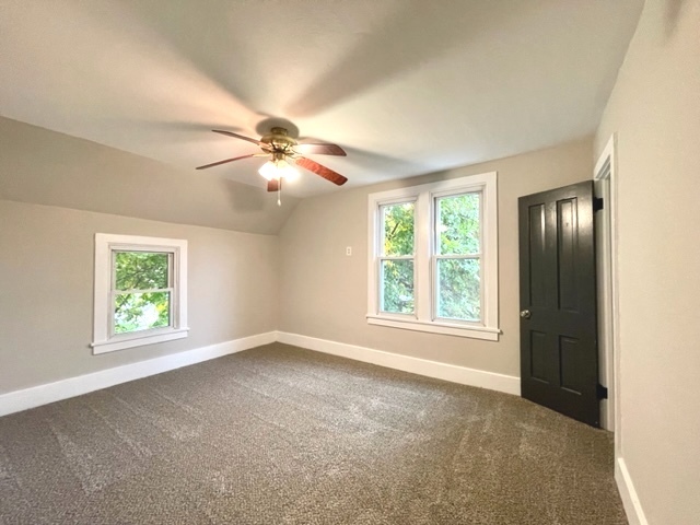 238 Lucas Street Sycamore, IL 60178 - Photo 18 of 28 an empty room with windows and chandelier fan