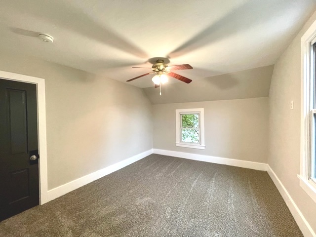 238 Lucas Street Sycamore, IL 60178 - Photo 19 of 28 an empty room with windows and chandelier fan