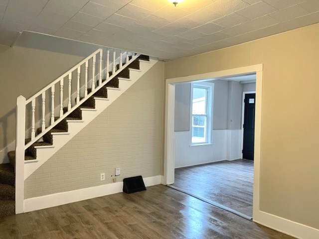 238 Lucas Street Sycamore, IL 60178 - Photo 2 of 28 a view of an empty room with wooden floor and stairs