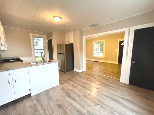 238 Lucas Street Sycamore, IL 60178 - Photo 5 of 28 a view of a kitchen with a sink and a refrigerator