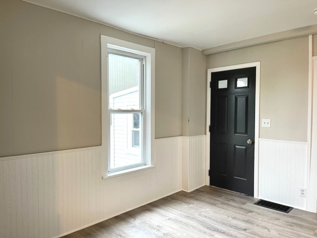 238 Lucas Street Sycamore, IL 60178 - Photo 10 of 28 a view of an empty room with wooden floor and a window