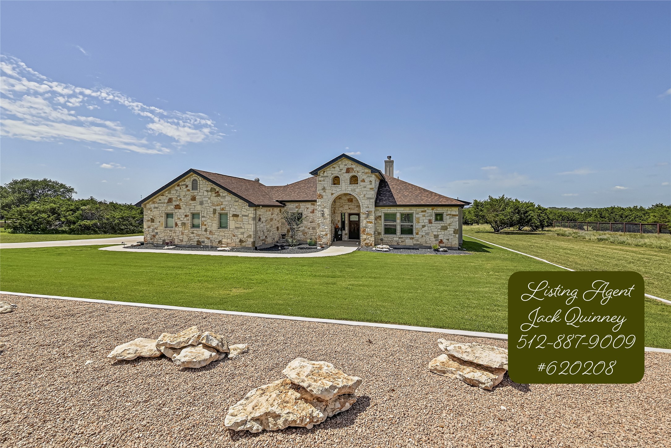 a front view of a house with a garden and yard
