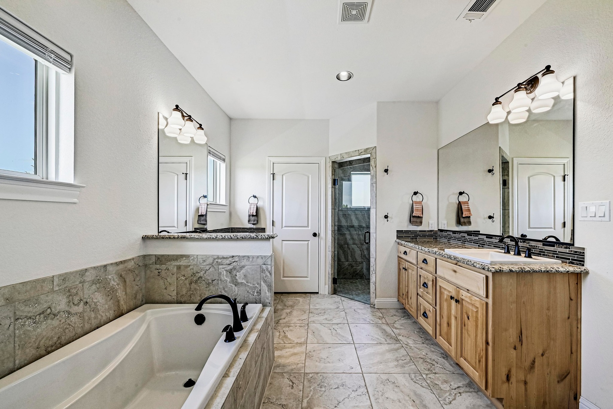 312 First Down Dash Burnet, TX 78611 - Photo 18 of 39 a spacious bathroom with a tub sink and mirror