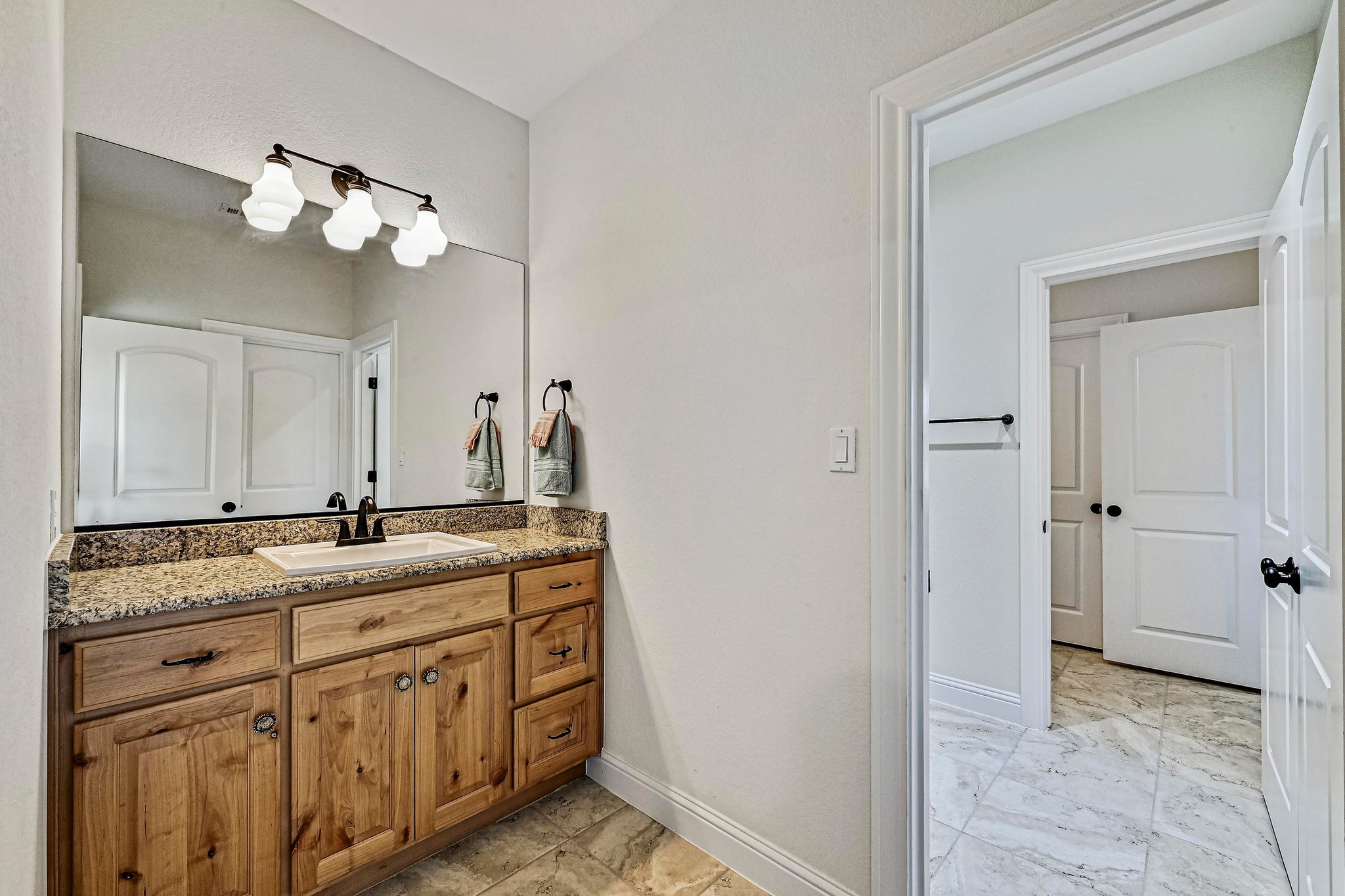 312 First Down Dash Burnet, TX 78611 - Photo 22 of 39 a bathroom with a granite countertop sink a mirror and a vanity