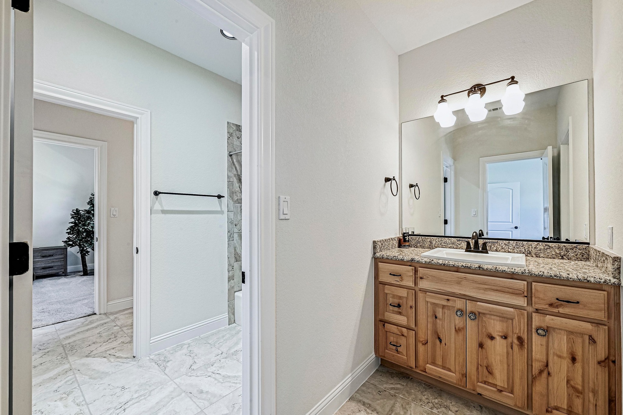 312 First Down Dash Burnet, TX 78611 - Photo 24 of 39 a bathroom with a granite countertop sink and a mirror
