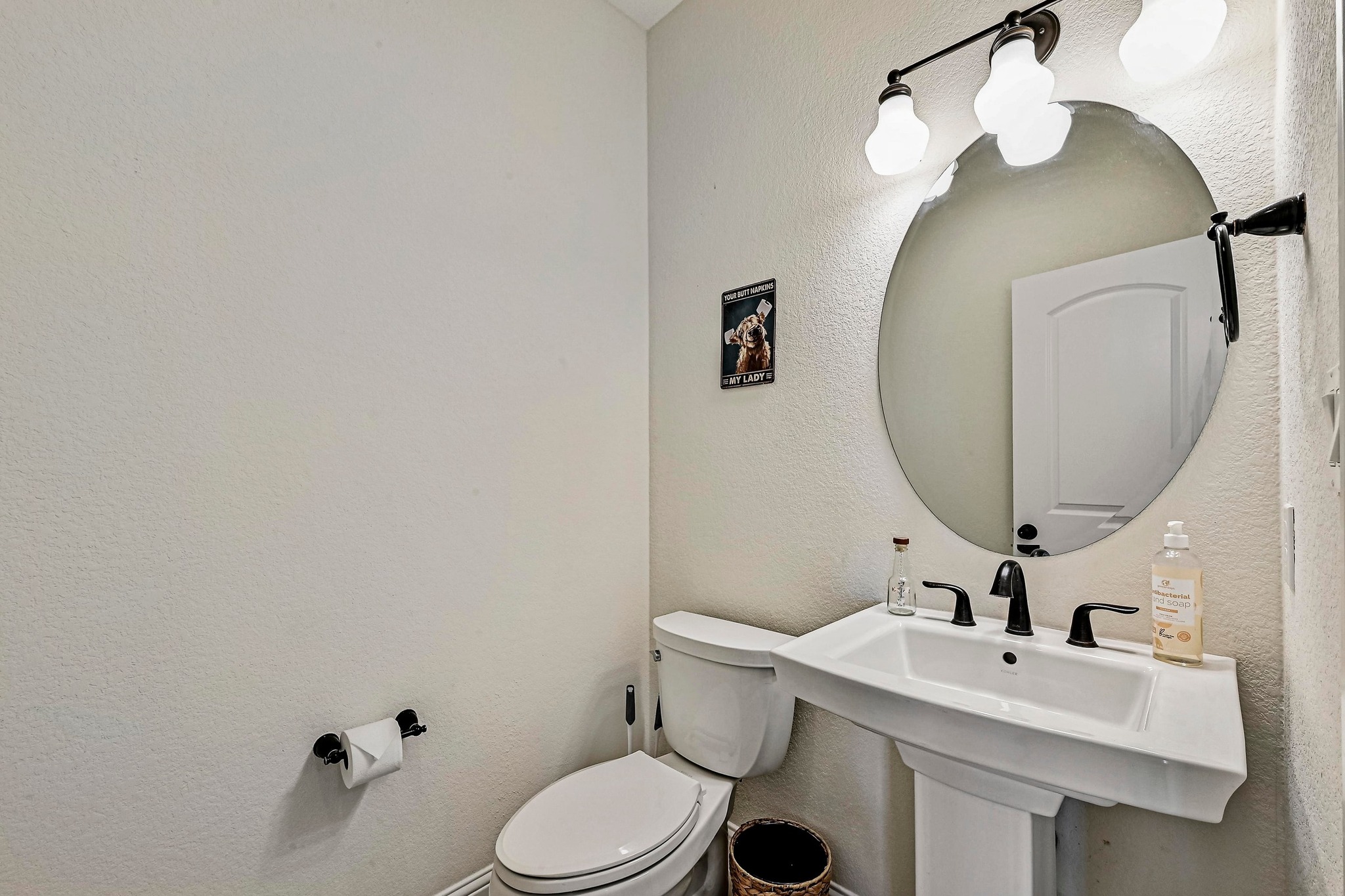 312 First Down Dash Burnet, TX 78611 - Photo 26 of 39 a bathroom with a sink mirror and toilet