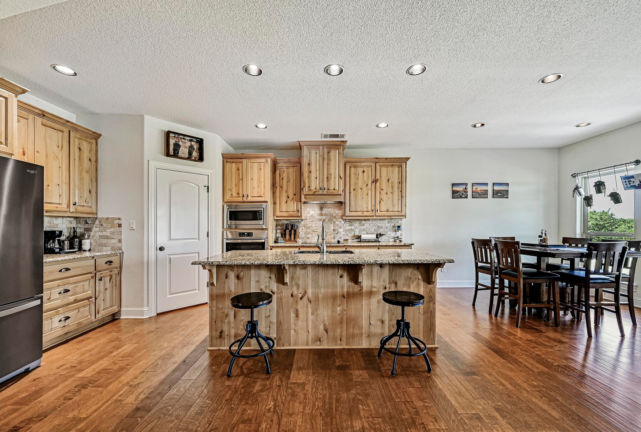 312 First Down Dash Burnet, TX 78611 - Photo 8 of 39 a open kitchen with stainless steel appliances granite countertop a dining table chairs stove refrigerator and cabinets