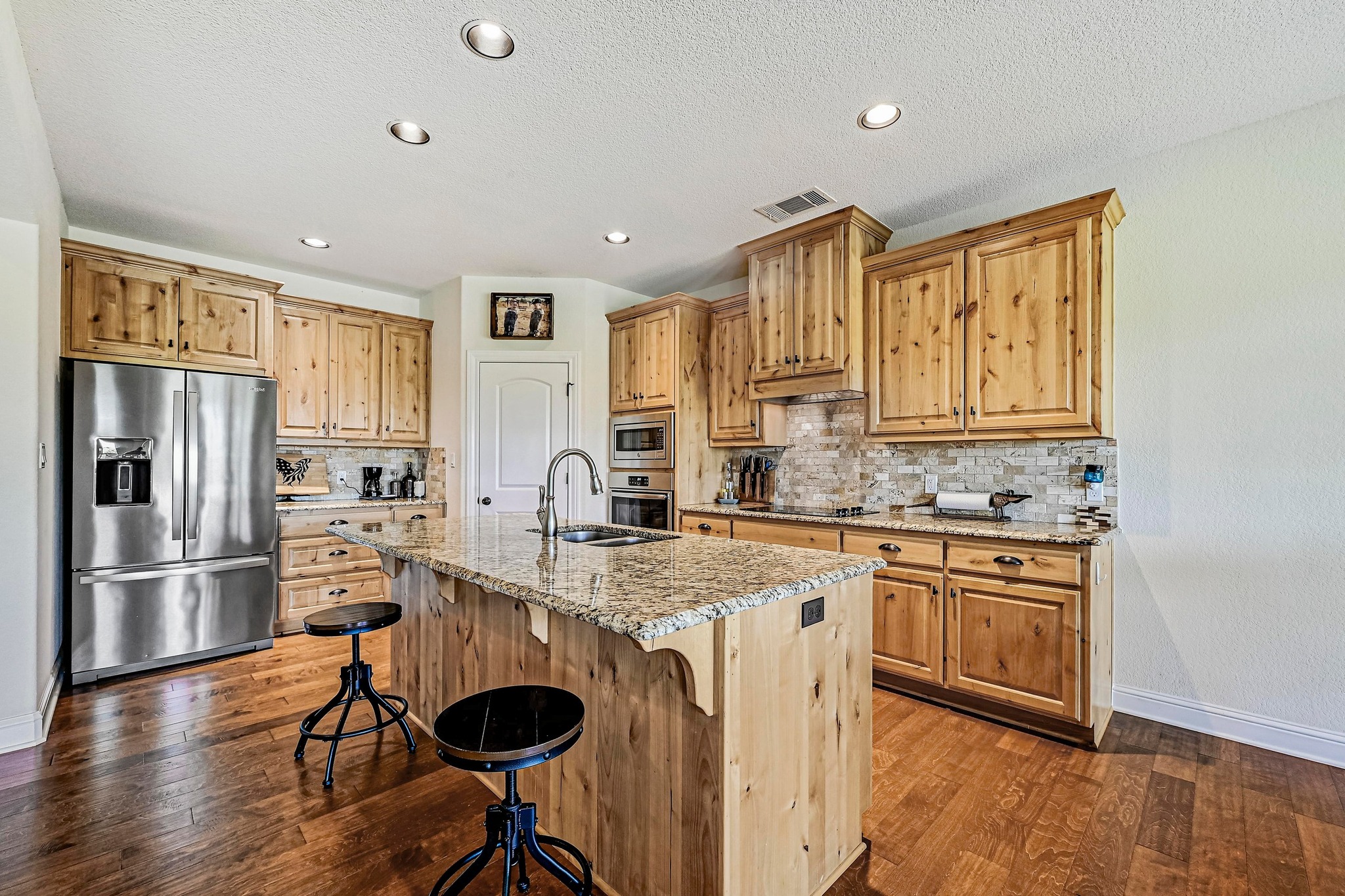 312 First Down Dash Burnet, TX 78611 - Photo 9 of 39 a kitchen with stainless steel appliances granite countertop a refrigerator and a stove top oven