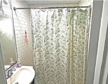 25-27 Marney Street Cambridge, MA 02141 - Photo 12 of 21 a bathroom with a shower curtain and a sink