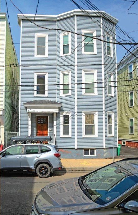 25-27 Marney Street Cambridge, MA 02141 - Photo 2 of 21 a front view of a house with cars parked