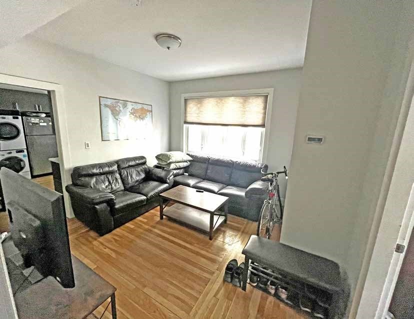 25-27 Marney Street Cambridge, MA 02141 - Photo 6 of 21 a living room with furniture and a window