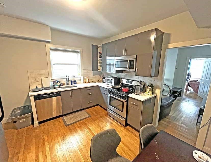 25-27 Marney Street Cambridge, MA 02141 - Photo 8 of 21 a kitchen with a sink appliances and cabinets