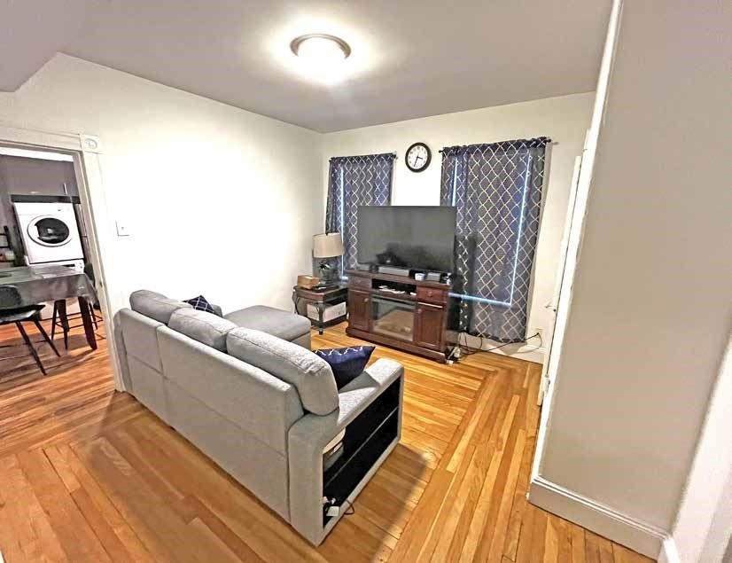 25-27 Marney Street Cambridge, MA 02141 - Photo 9 of 21 a living room with furniture and a flat screen tv