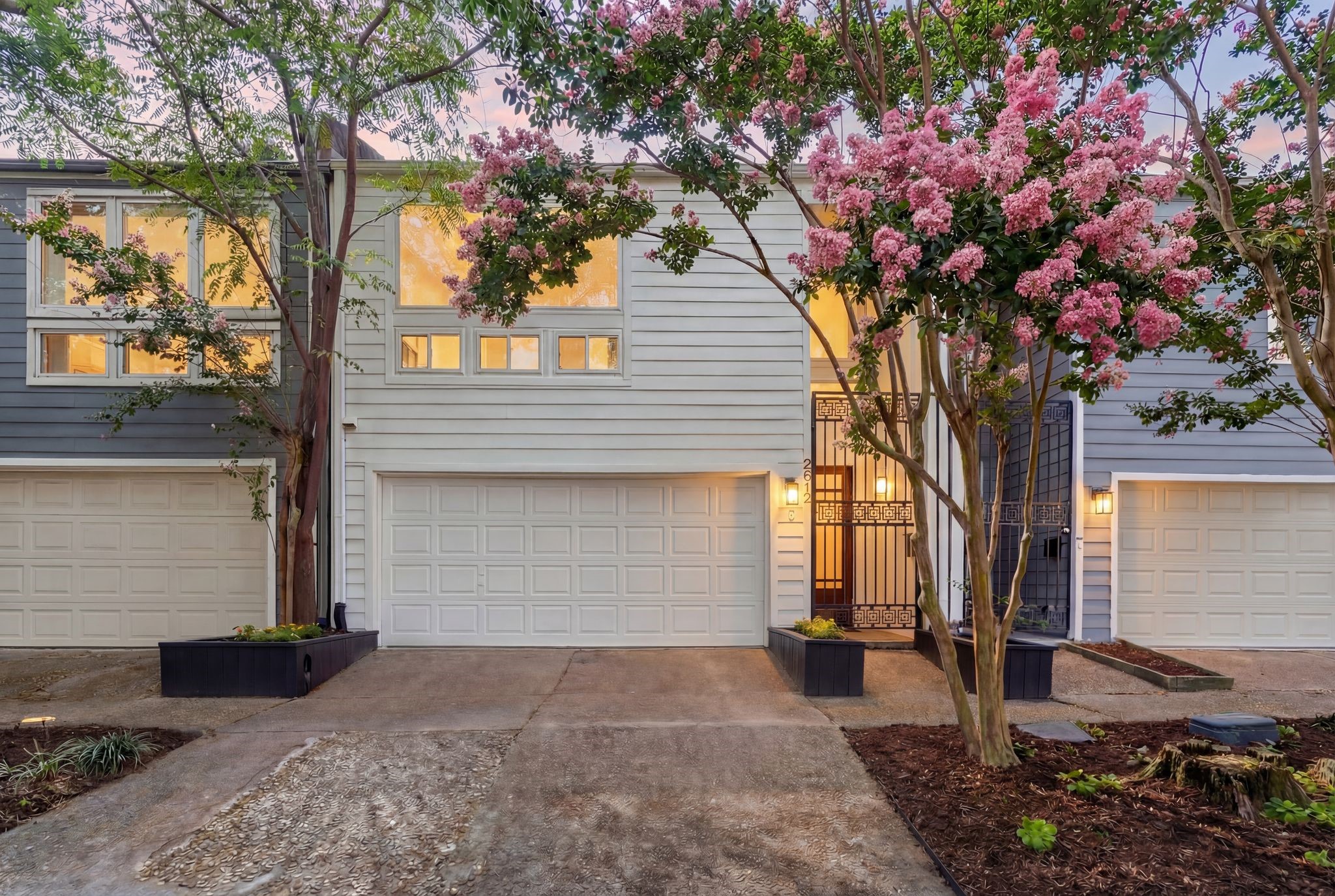 a front view of a house with a tree
