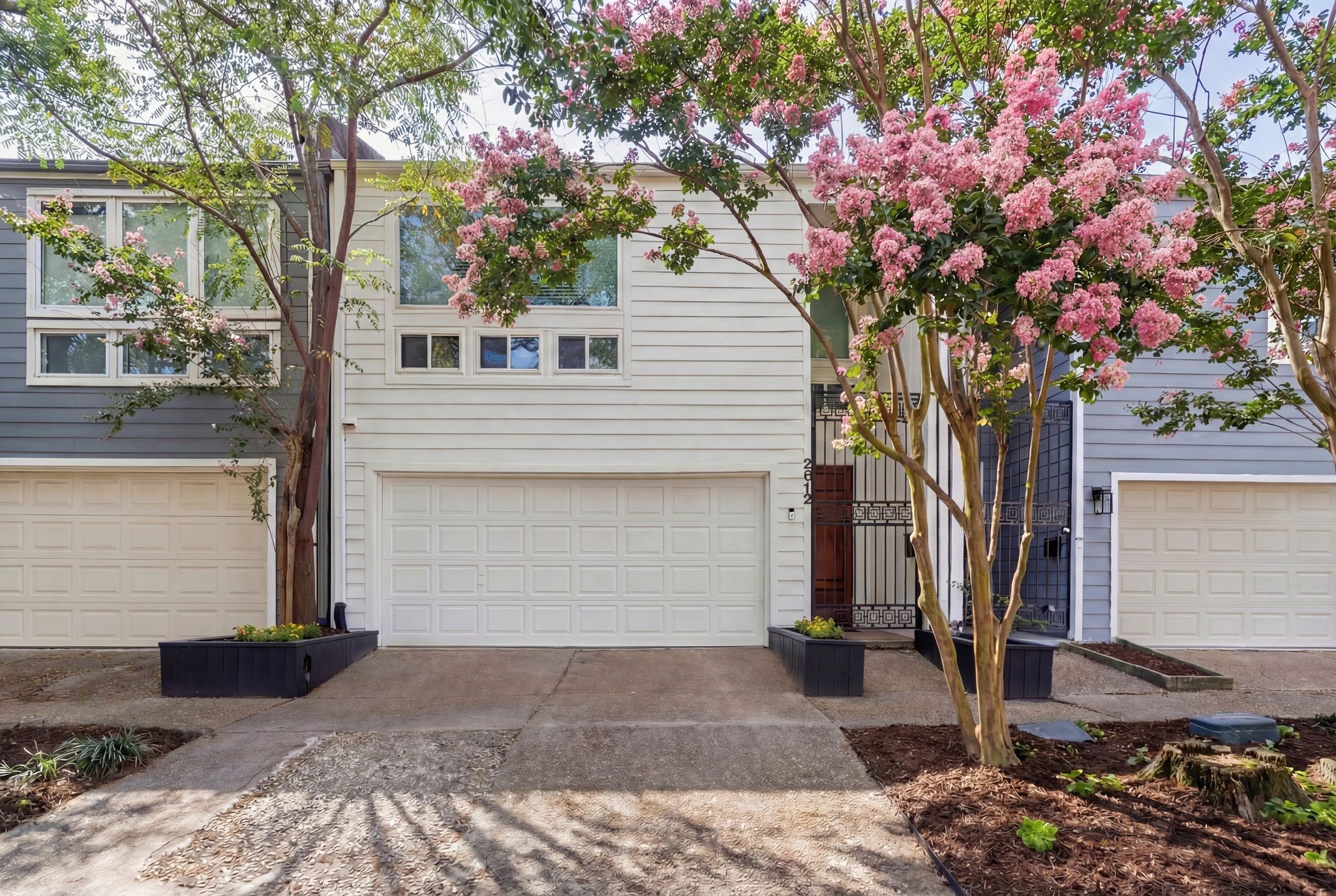 Bright white exterior paint, gated entry, and generous driveway create strong curb appeal in this Cherryhurst location. This image has been digitally enhanced and landscaping may not be an exact depiction of the actual property.