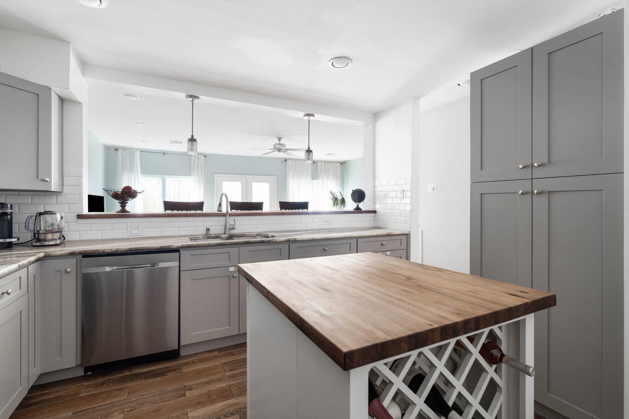 2612 Yupon Street Houston, TX 77006 - Photo 12 of 40 Island with built in wine storage anchor the kitchen while maintaining sightlines into the living room, pantry access, and stainless steel dishwasher for everyday convenience.