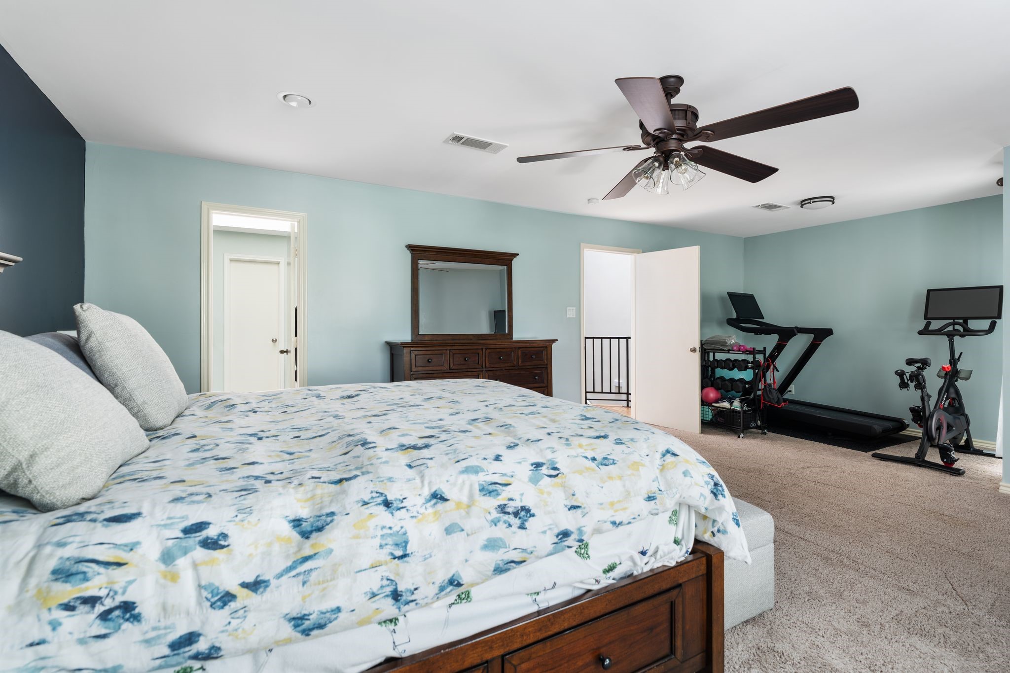 2612 Yupon Street Houston, TX 77006 - Photo 22 of 40 Expansive primary bedroom includes a flexible sitting area currently used as a home gym, offering space for a lounge, office nook, or reading corner.