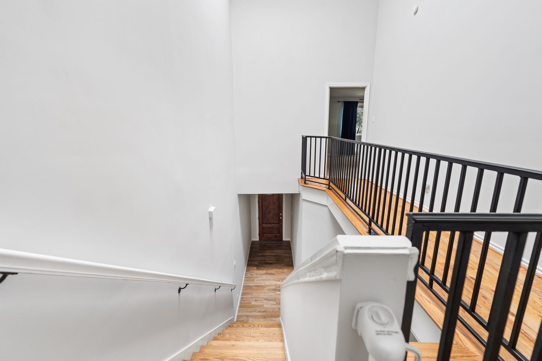 2612 Yupon Street Houston, TX 77006 - Photo 34 of 40 View down the staircase showcases the open second floor landing, skylight, and welcoming sightline to the front entry below.