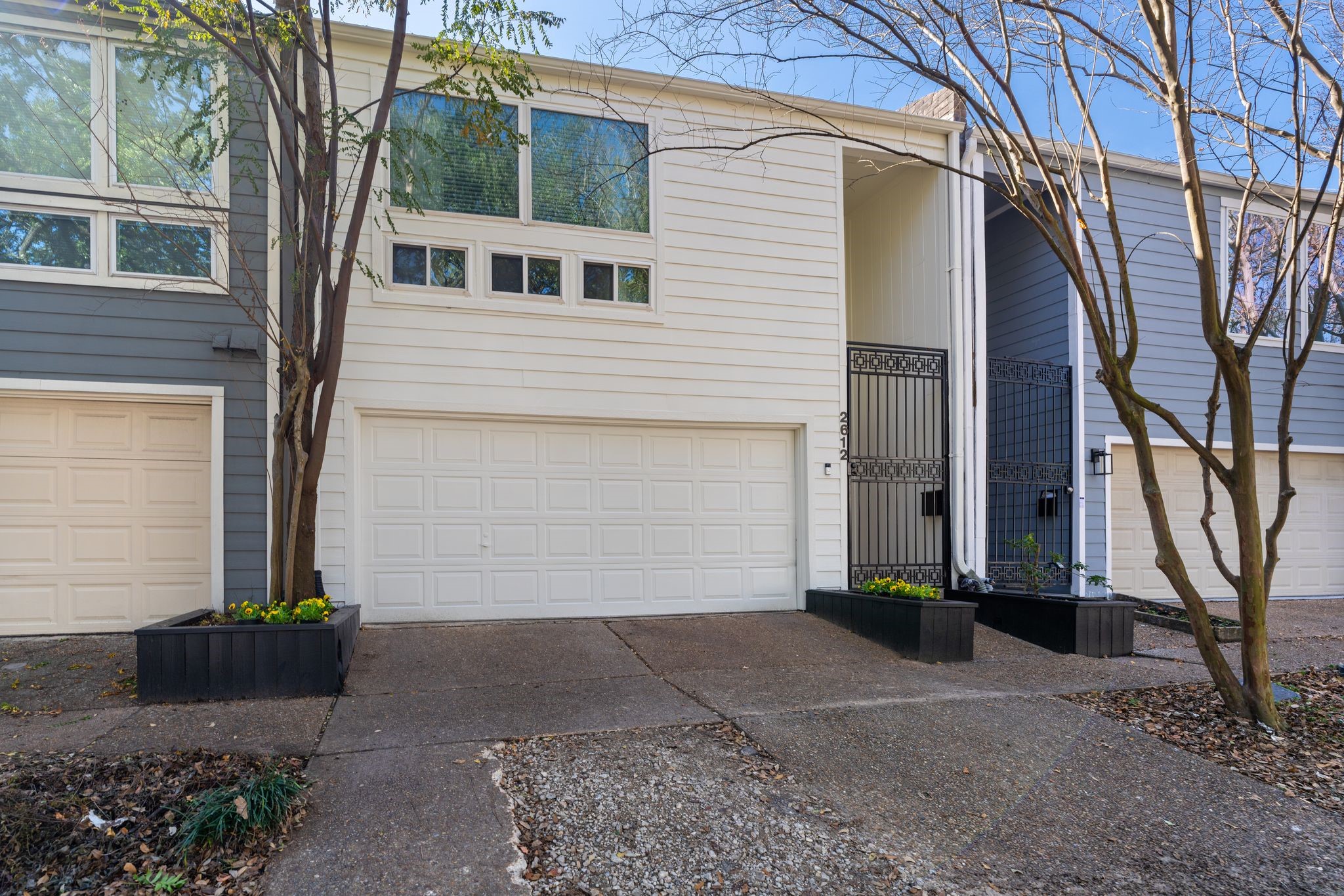 2612 Yupon Street Houston, TX 77006 - Photo 36 of 40 Fresh alabaster white exterior paint, black planter boxes, mature crepe myrtles, sidewalks, and double wide driveway enhance curb appeal and walkability.