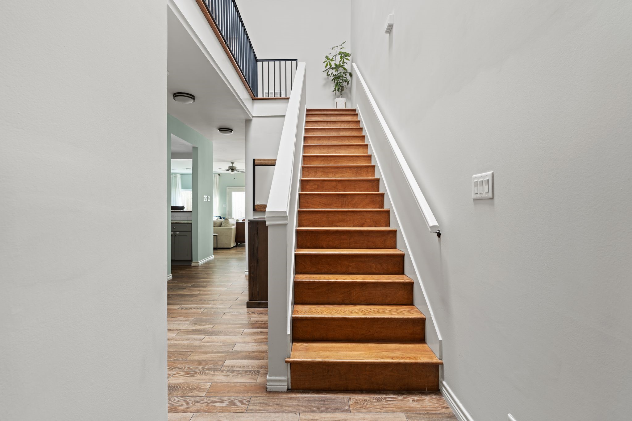 2612 Yupon Street Houston, TX 77006 - Photo 9 of 40 Double height entry with staircase and skylight fills the home with natural light while creating a bright and welcoming arrival experience.
