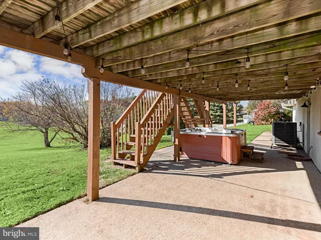 an aerial view of a house with a garden and mountain view in back