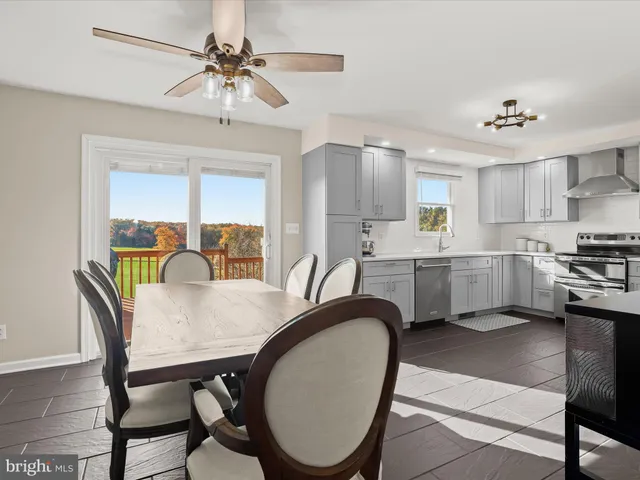 a kitchen with white cabinets and appliances