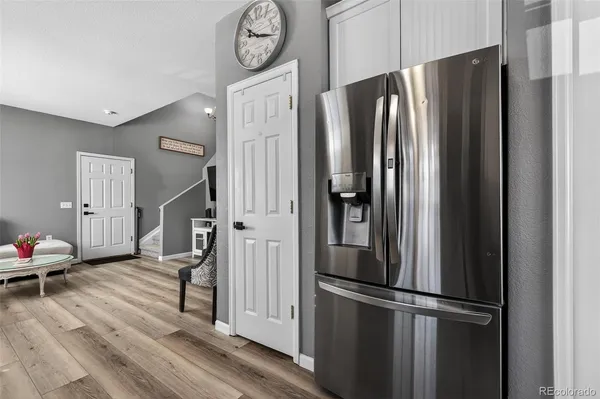 a metallic refrigerator freezer sitting in a kitchen