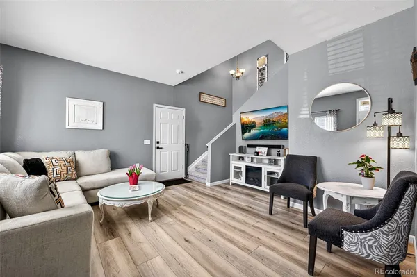 a living room with furniture and wooden floor
