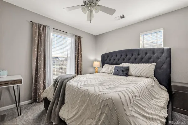 a bedroom with a large bed and a chandelier