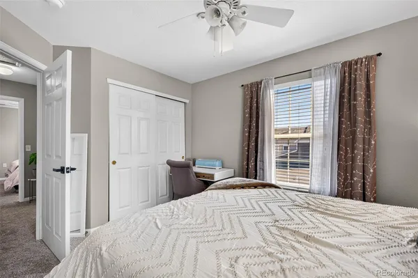 a bedroom with a bed and a desk