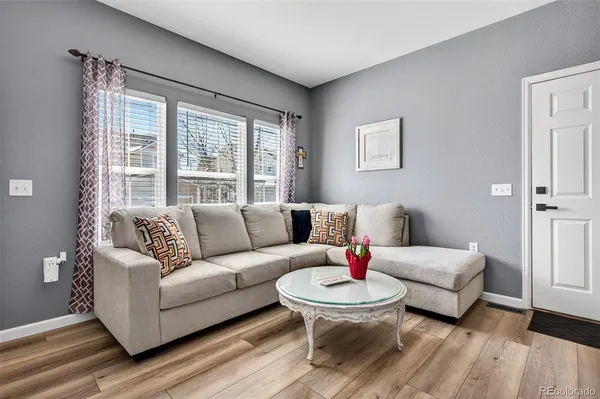 a living room with furniture and a large window