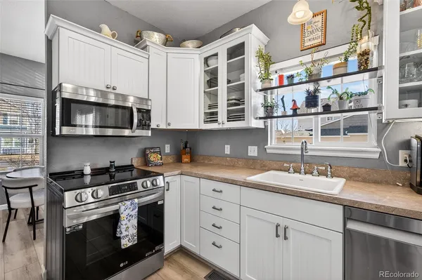 a kitchen with stainless steel appliances granite countertop a stove a sink and a microwave