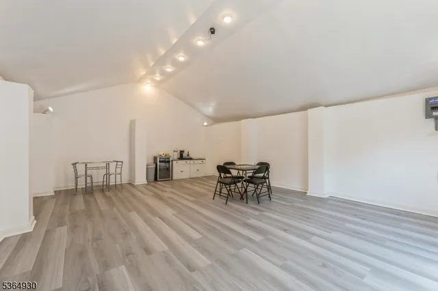 a view of a dining room with furniture and chandelier