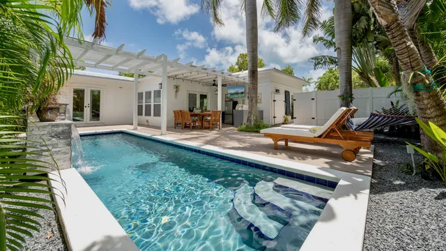 a view of a house with backyard porch and sitting area
