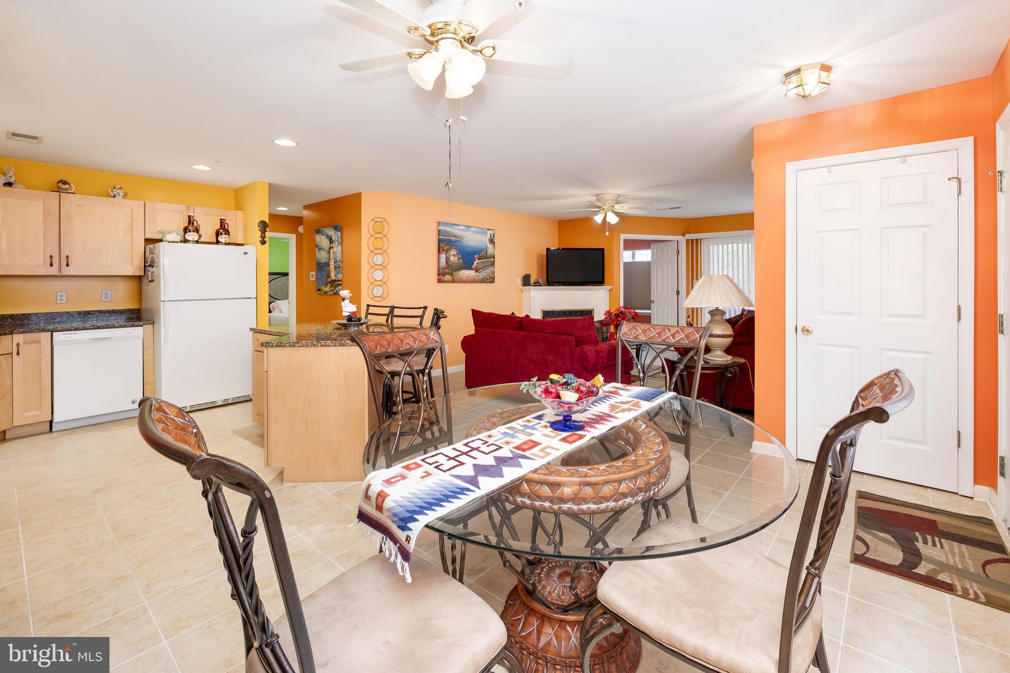 11427 Manklin Creek Road, Unit 7 Ocean Pines, MD 21811 - Photo 15 of 42 a view of a dining room with furniture a chandelier and large windows