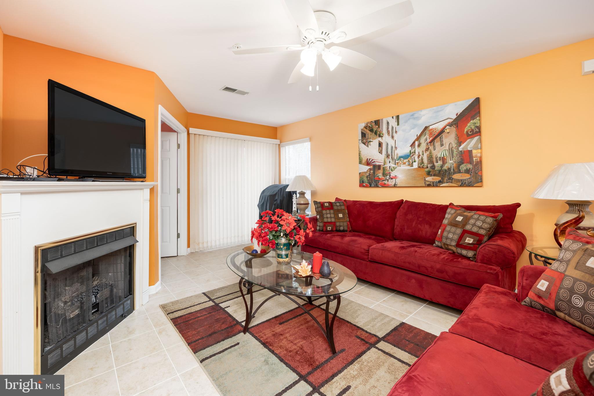 11427 Manklin Creek Road, Unit 7 Ocean Pines, MD 21811 - Photo 17 of 42 a living room with furniture a flat screen tv and a fireplace