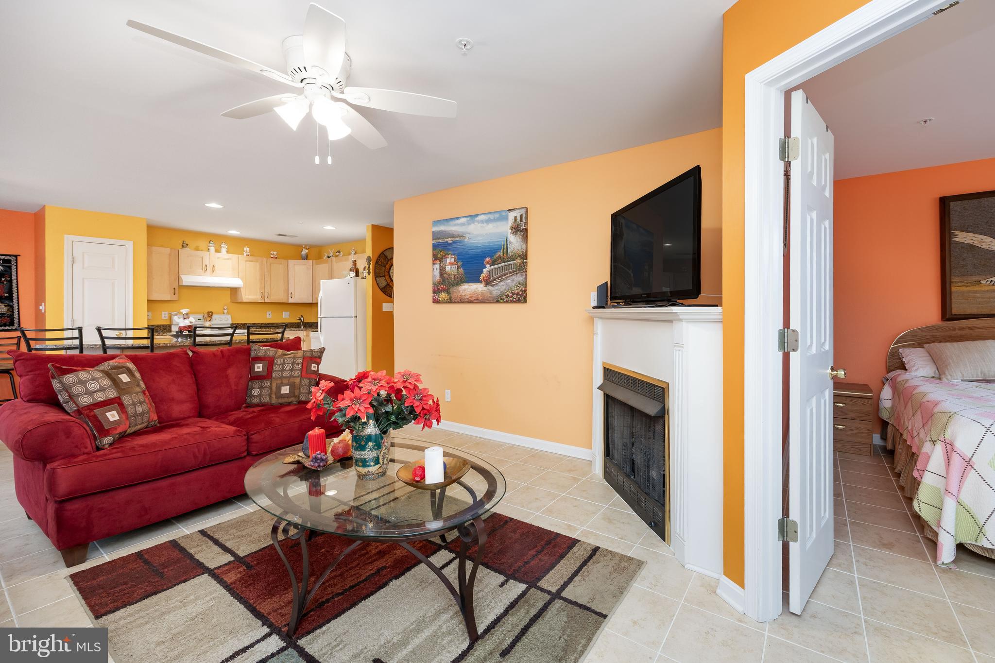 11427 Manklin Creek Road, Unit 7 Ocean Pines, MD 21811 - Photo 19 of 42 a living room with furniture a flat screen tv and a fireplace