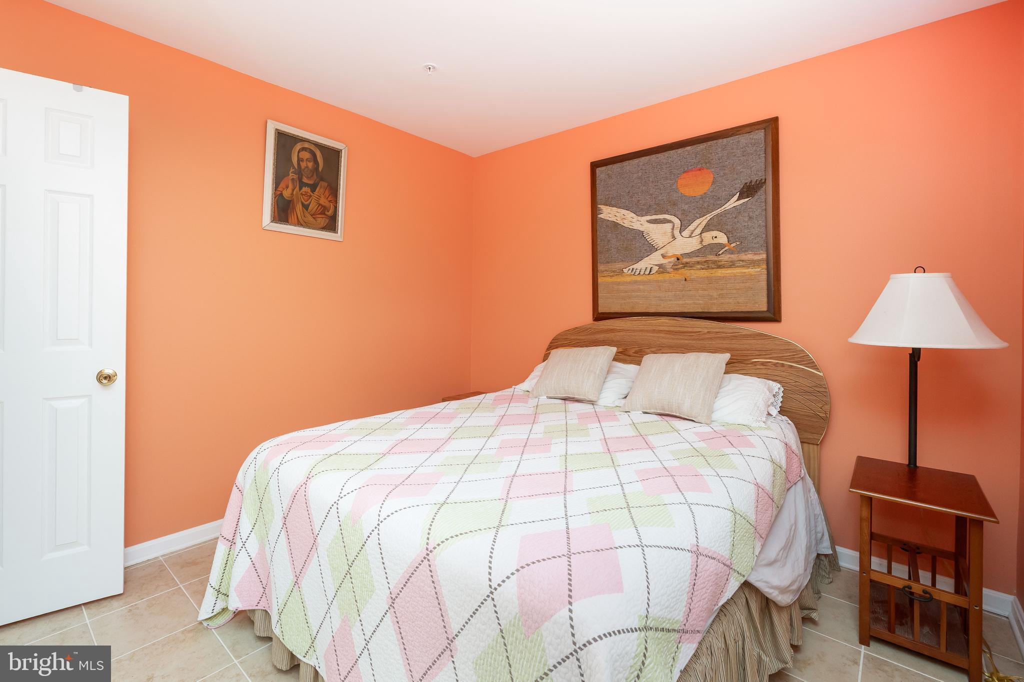 11427 Manklin Creek Road, Unit 7 Ocean Pines, MD 21811 - Photo 21 of 42 a bedroom with a bed and wall painting