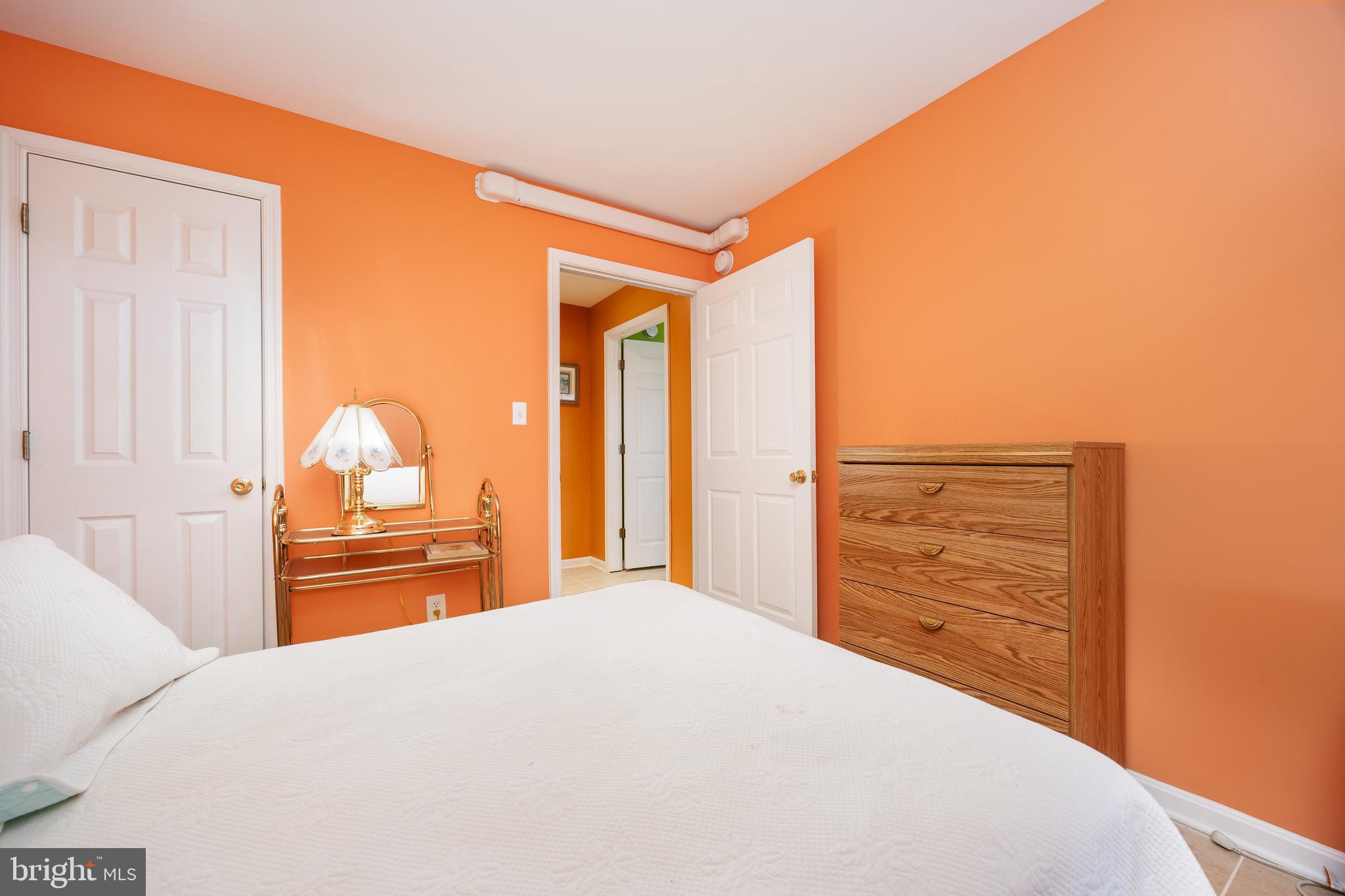 11427 Manklin Creek Road, Unit 7 Ocean Pines, MD 21811 - Photo 27 of 42 a bedroom with a bed and a dresser