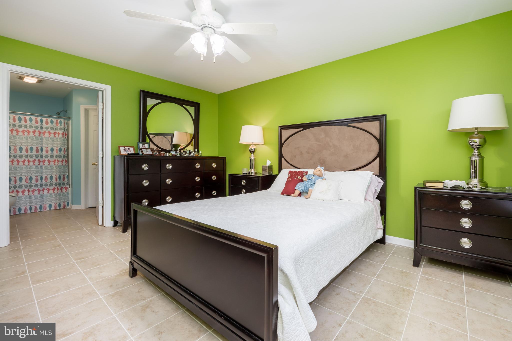 11427 Manklin Creek Road, Unit 7 Ocean Pines, MD 21811 - Photo 30 of 42 a bedroom with a bed and a chandelier