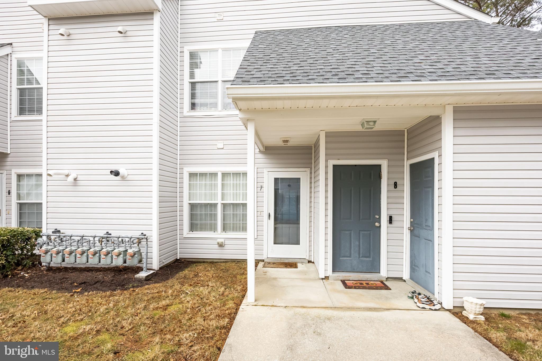 11427 Manklin Creek Road, Unit 7 Ocean Pines, MD 21811 - Photo 3 of 42 a front view of a house with a yard