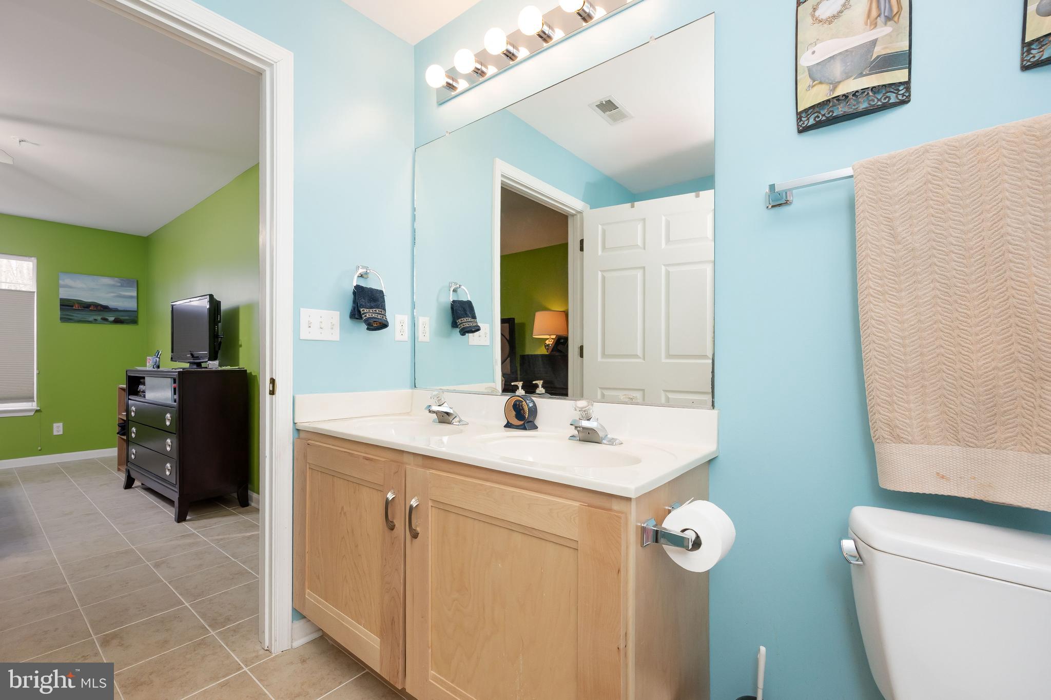 11427 Manklin Creek Road, Unit 7 Ocean Pines, MD 21811 - Photo 34 of 42 a bathroom with a sink a toilet and mirror