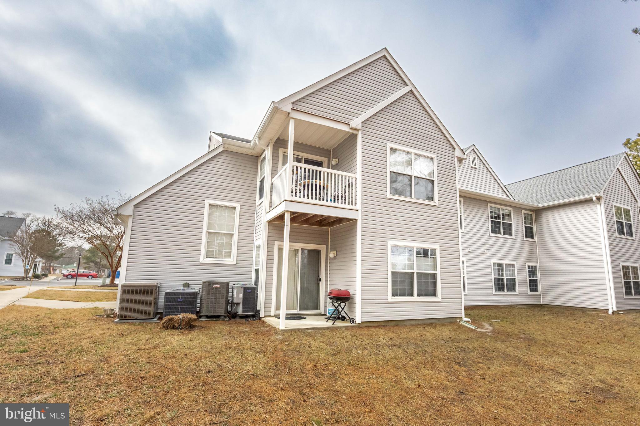 11427 Manklin Creek Road, Unit 7 Ocean Pines, MD 21811 - Photo 37 of 42 a view of a house with a yard and sitting space