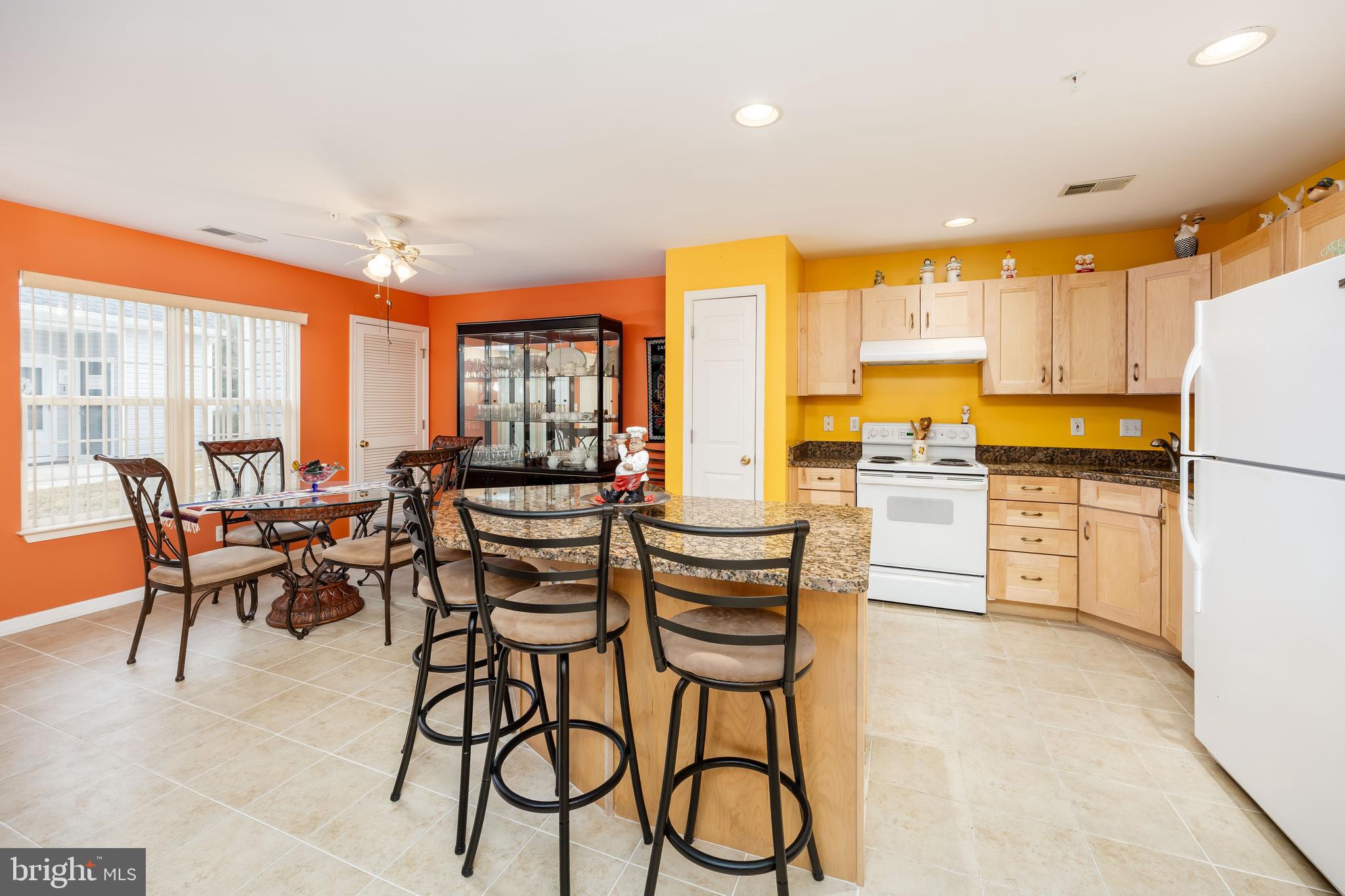 11427 Manklin Creek Road, Unit 7 Ocean Pines, MD 21811 - Photo 6 of 42 a kitchen with stainless steel appliances kitchen island granite top and refrigerator